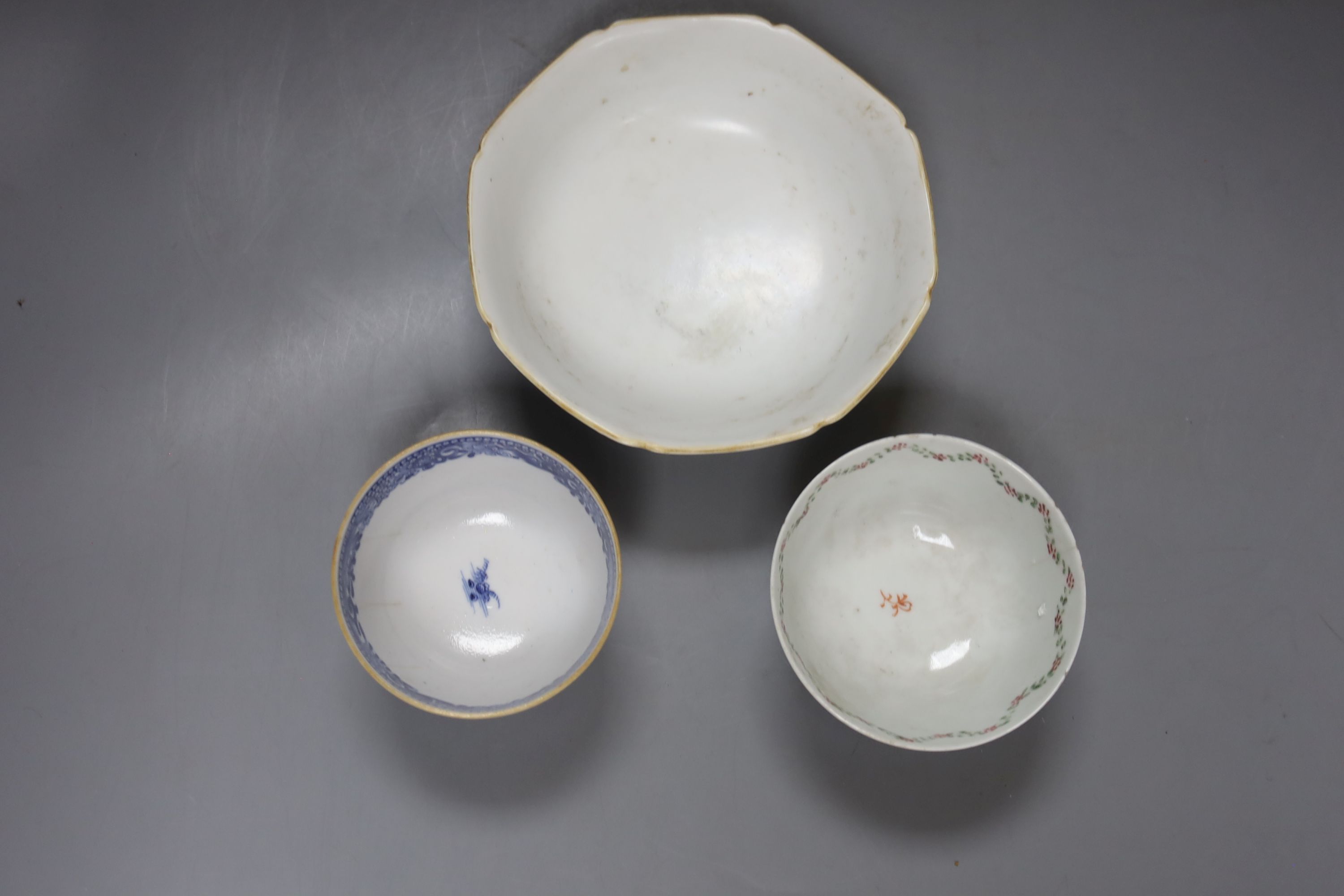 Two Chinese famille rose bowls together with a similar blue and white bowl, largest diameter 14cm